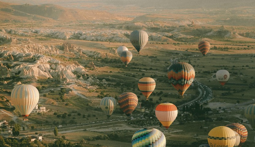 Hot air balloons over a valley